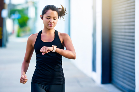 Woman running with smartwatch